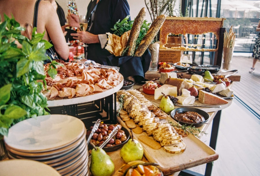 A generous grazing table spread with cold cuts, cheeses and fresh fruit